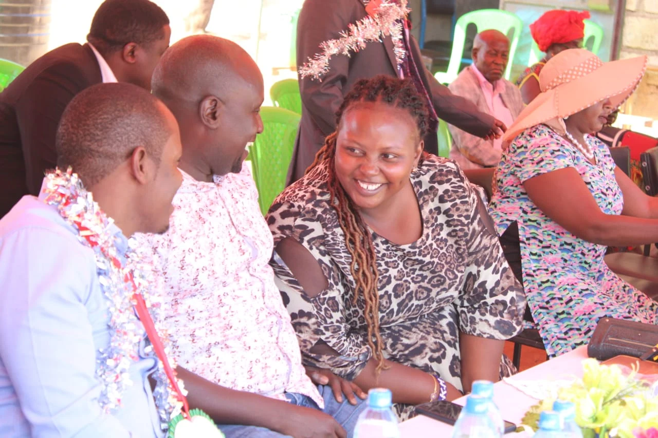 Community members in conversation at a school gathering
