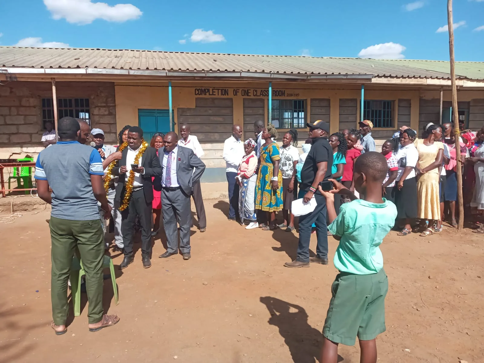 The gathering continues outside the classrooms.