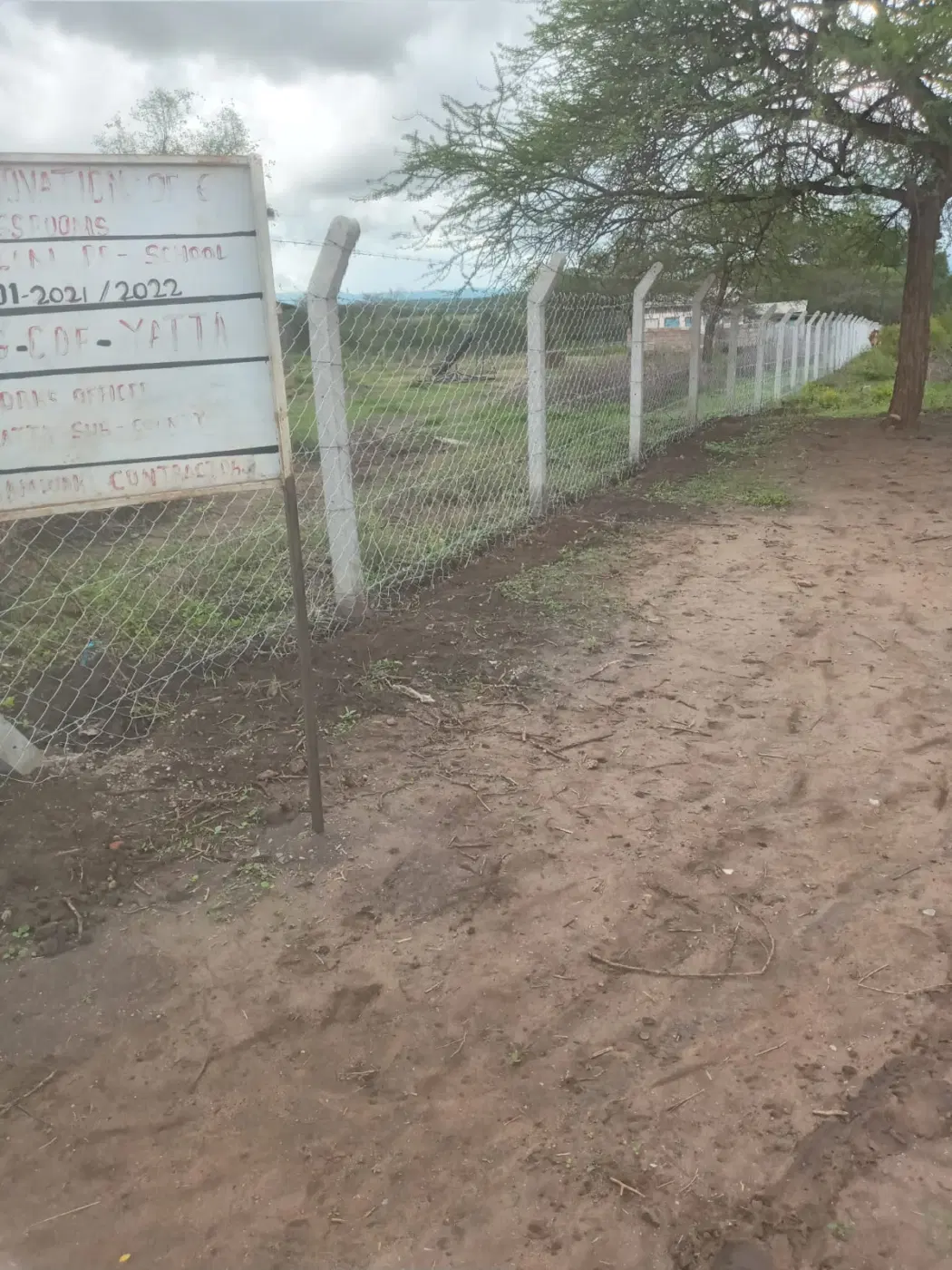 The school sign and newly fenced boundary.