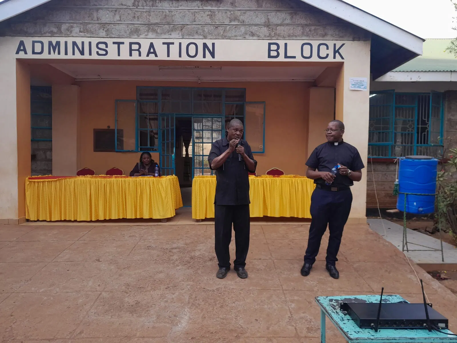 Fr. Christopher Musyoka and Fredrick Munyao address students at the school.