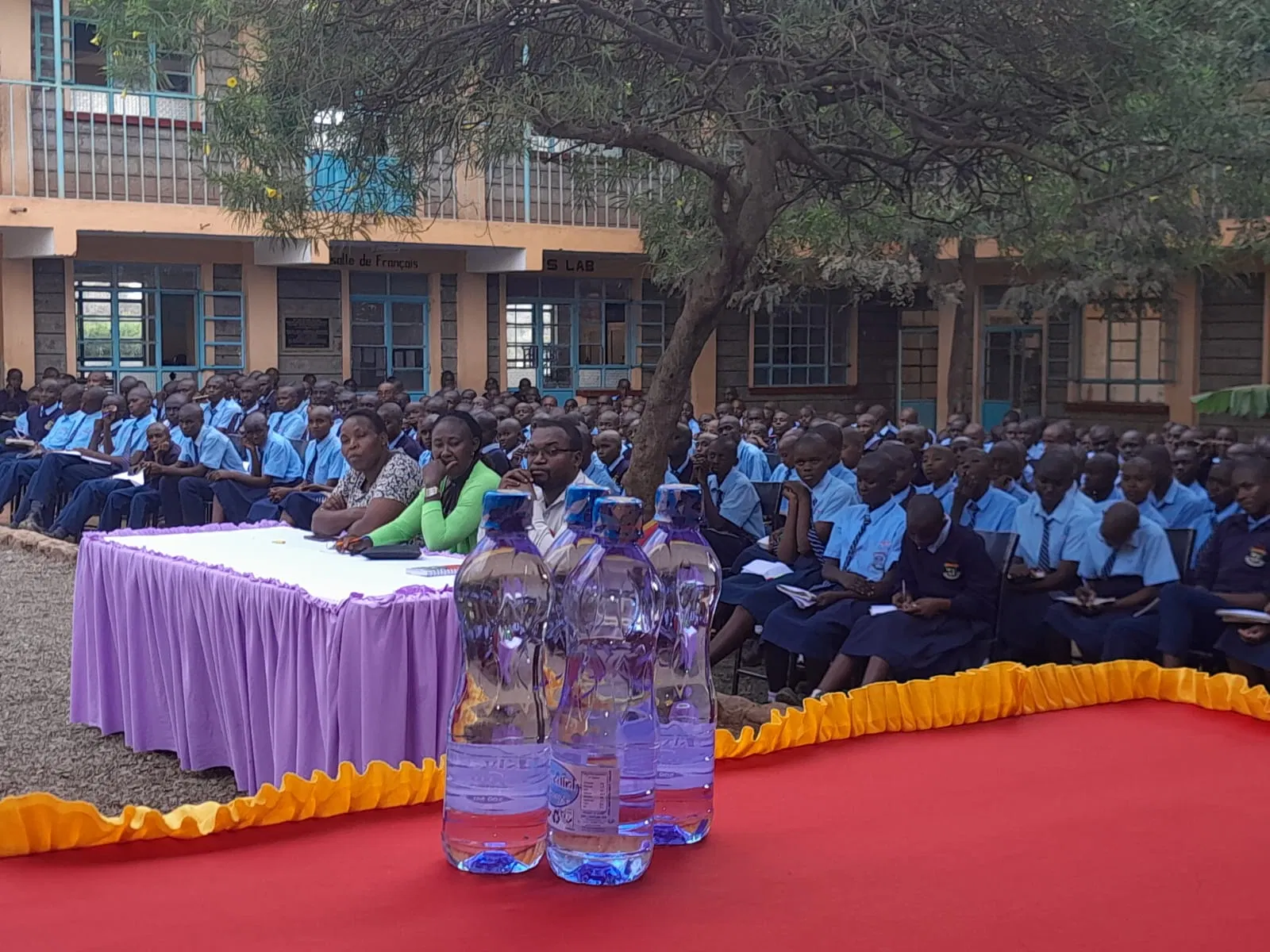School representatives and guests gather after the visit.