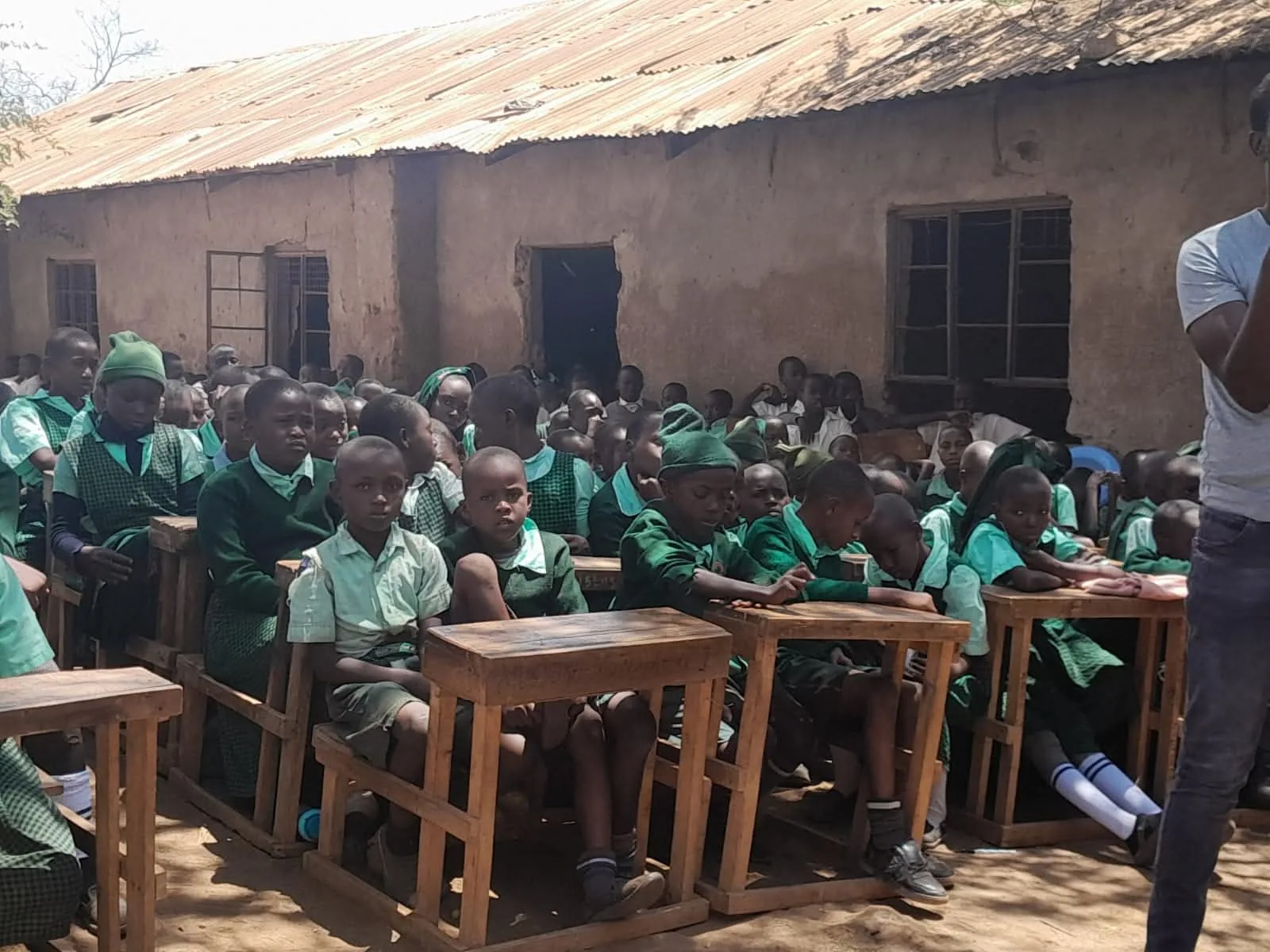 Pupils gather in a classroom during an alumni school visit.