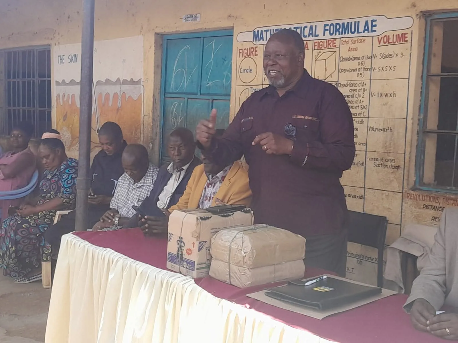 An alumnus speaks with learners and school representatives.