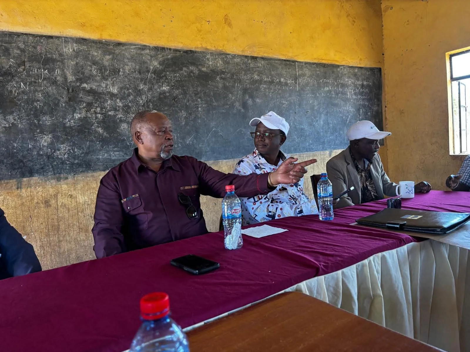 Alumni and school representatives meet during a visit.