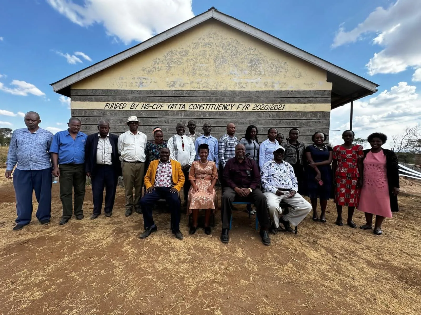 Alumni meet learners and staff outside the school building.