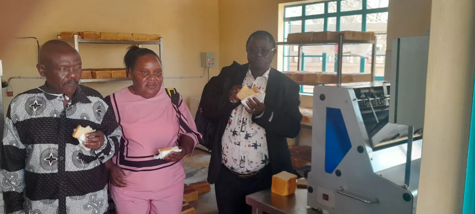 The principal and visitors inspect the bakery facilities.