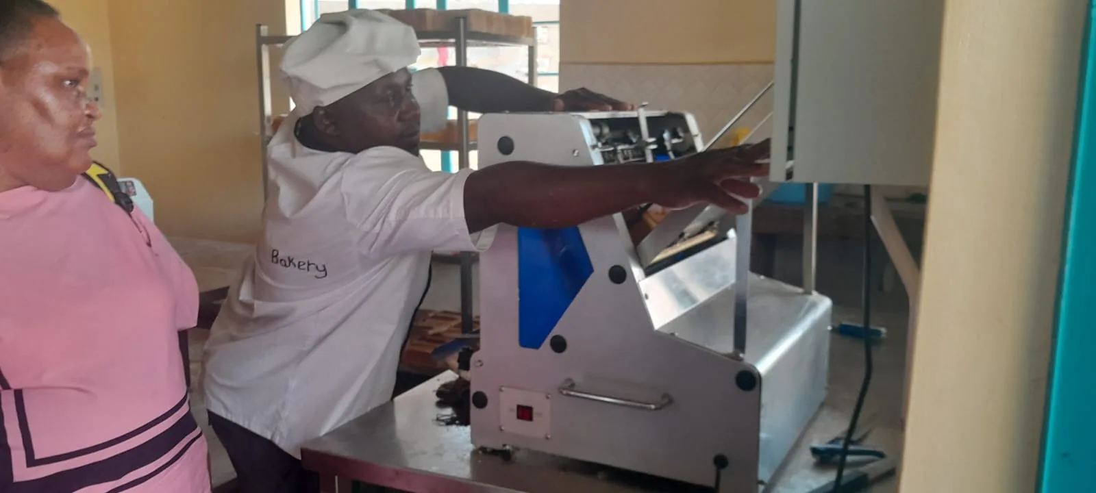 Association officials learn about the bakery operation.